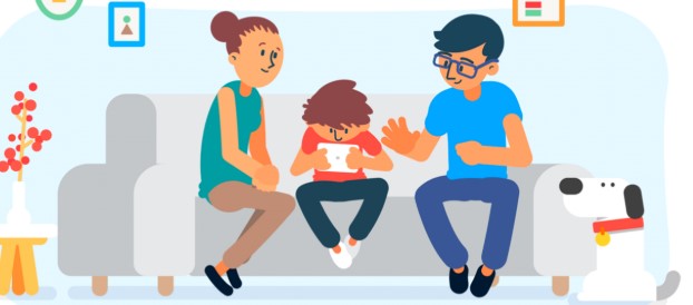 Image of a family on a sofa while the child holds a device